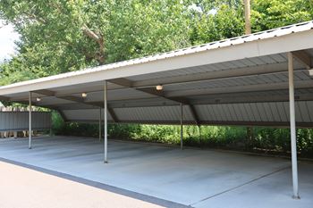 A parking structure with a roof and pillars
